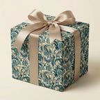Elegant gift box wrapped in blue floral wrapping paper with a satin gold ribbon.