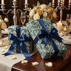 Elegant gift boxes wrapped in floral paper with blue satin ribbon, perfect for luxury occasions.