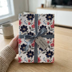 Elegant navy and pink floral wrapping paper with a grey ribbon bow by Wrapped Studios.