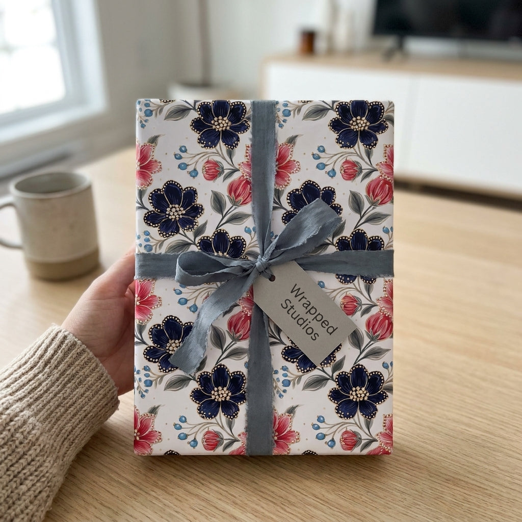 Elegant navy and pink floral wrapping paper with a grey ribbon bow by Wrapped Studios.