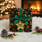 Elegant floral Christmas gift wrap on a square box with a green ribbon and "Happy Holidays" star ornament.