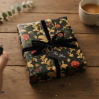 Elegant floral wrapping paper on a present with black velvet ribbon and a "For You" gift tag.