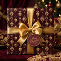 Elegant burgundy and gold vintage Christmas wrapping paper with a satin bow by Wrapped Studios.