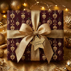 Luxury burgundy and gold Christmas wrapping paper with an elegant ribbon bow by Wrapped Studios.