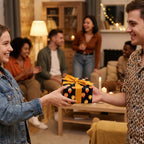 Woman giving a birthday gift in black balloon wrapping paper with yellow ribbon at a party. Wrapped Studios.