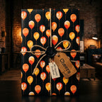 Black watercolor balloon birthday wrapping paper with rustic twine bow, by Wrapped Studios.