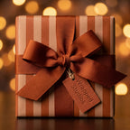 Luxury brown striped wrapping paper with a copper ribbon bow and Wrapped Studios gift tag.