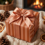 Copper striped holiday wrapping paper with a luxury satin bow by Wrapped Studios.
