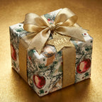 Luxury Christmas wrapping paper with watercolor ornaments and a gold bow by Wrapped Studios.