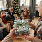 Elegant Christmas wrapping paper with blue ornament pattern and green ribbon by Wrapped Studios.