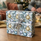 Elegant Christmas wrapping paper with blue and gold ornaments, tied with a silver ribbon by Wrapped Studios.