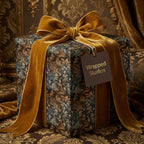 Wrapped Studios luxury gift wrap. Elegant floral wrapping paper with gold velvet bow.