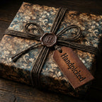 Elegant gift wrapped in vintage floral paper with brown twine and a Handpicked tag.