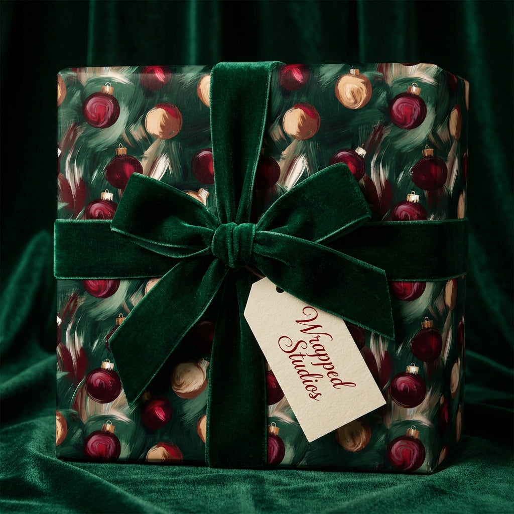Square gift box wrapped in Wrapped Studios' dark green Christmas ornament wrapping paper with velvet ribbon.