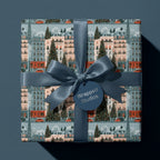 Vintage Paris Christmas wrapping paper with a blue satin ribbon bow on a holiday gift by Wrapped Studios.