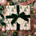 Luxury pink and green Christmas wrapping paper with watercolor trees and green velvet bow by Wrapped Studios.