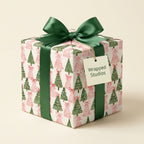 Pink and green Christmas tree wrapping paper tied with a luxury green bow, by Wrapped Studios.