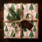 Christmas gift wrap with green and pink tree pattern, tied with twine and Dad tag by Wrapped Studios.