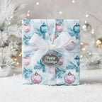 Elegant Christmas gift wrap featuring ornament pattern, white ribbon, and "Happy Holidays" tag.