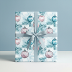 Square gift wrapped in Wrapped Studios Christmas ornament wrapping paper with a blue ribbon.