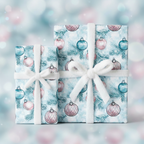 Two gifts wrapped in light blue Christmas ornament wrapping paper with white ribbons.
