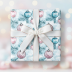 Square gift wrapped in blue Christmas wrapping paper with ornament and evergreen branch pattern.