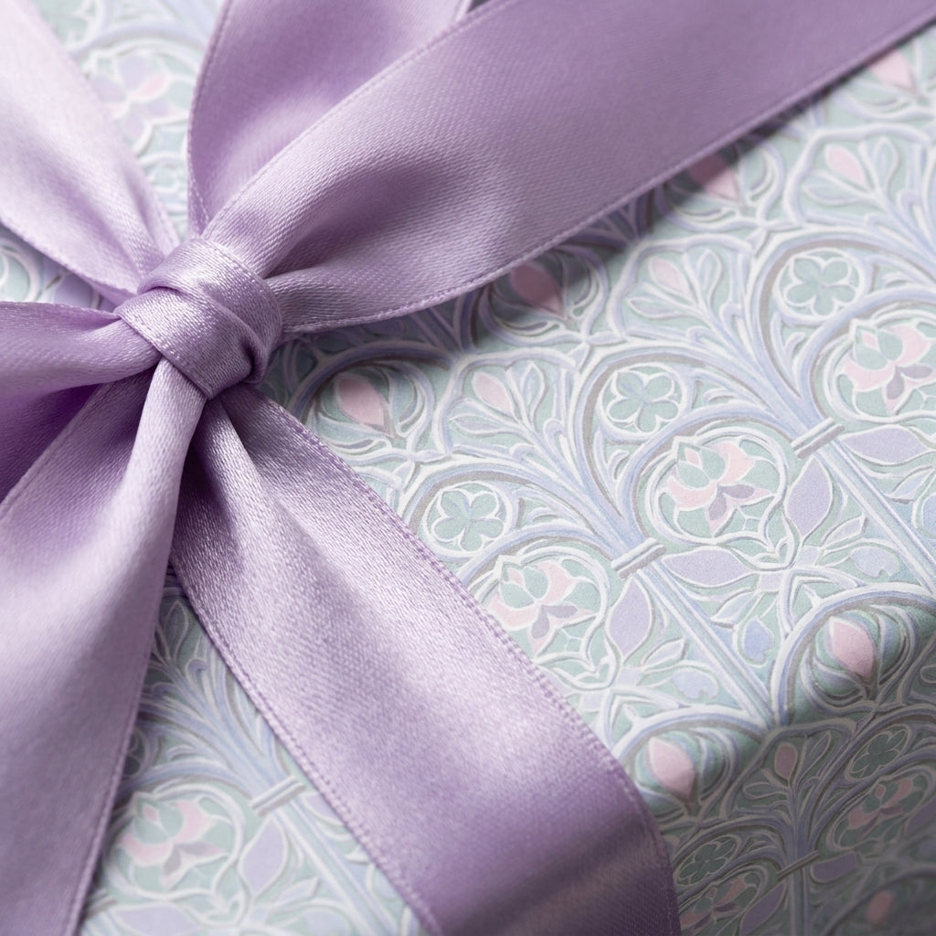 Pastel luxury gift wrap with elegant vintage pattern and purple satin ribbon by Wrapped Studios.