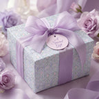 Luxury lavender floral wrapping paper on a gift box with a purple satin bow from Wrapped Studios.