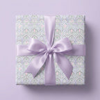 Elegant pastel Art Nouveau floral wrapping paper with lavender satin bow by Wrapped Studios.