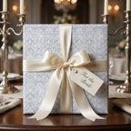 Luxury wedding wrapping paper in pastel lavender floral pattern with a cream satin bow by Wrapped Studios.