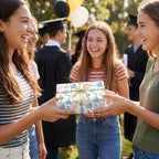Friends exchanging a gift in graduation wrapping paper with pink and blue watercolor caps by Wrapped Studios.