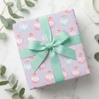 Pastel Christmas wrapping paper with watercolor ornament pattern and mint green ribbon by Wrapped Studios.