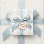 Gift box in pastel polka dot wrapping paper with gray satin bow and "Warmest Wishes" tag.