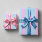 Pastel pink and blue striped baby shower gift wrap with satin bows, by Wrapped Studios.