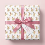 Cute monkey wrapping paper by Wrapped Studios with a pink satin bow on a kids birthday gift box.