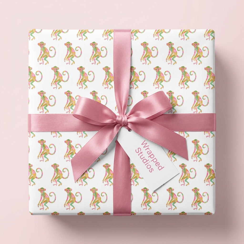Cute monkey wrapping paper by Wrapped Studios with a pink satin bow on a kids birthday gift box.