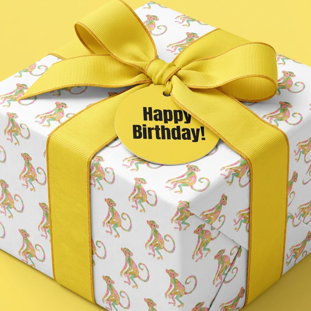 Cute monkey birthday wrapping paper with a yellow ribbon and Happy Birthday tag, by Wrapped Studios.