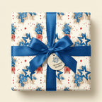 Patriotic floral wrapping paper with blue flowers, stars, and a satin bow from Wrapped Studios.