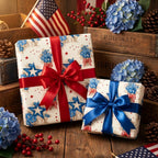 4th of July patriotic wrapping paper with red and blue satin bows on rustic gifts by Wrapped Studios.