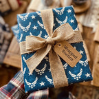 Air Force wrapping paper in blue with white stars and a rustic burlap bow by Wrapped Studios.