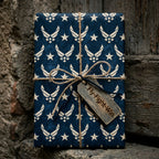 Patriotic Air Force wrapping paper with stars, twine, and Fly-Fight-Win tag by Wrapped Studios.