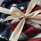 Gift box wrapped in patriotic American flag themed wrapping paper with a tied cream-colored satin ribbon.