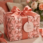 Elegant dusty rose floral wrapping paper with a matching satin ribbon and tag by Wrapped Studios.