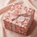 Elegant floral wrapping paper in blush pink with a ribbon and 'Just Because' gift tag by Wrapped Studios.