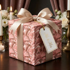 Luxury floral wedding wrapping paper in dusty rose with a champagne bow and Mr. and Mrs. tag by Wrapped Studios.