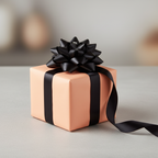 Elegant peach wrapping paper with a black satin ribbon and bow on a square gift box.