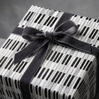 Piano keys wrapping paper with a luxury grey velvet bow on a gift box from Wrapped Studios.