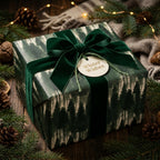 Pine forest Christmas wrapping paper with a luxury green velvet bow by Wrapped Studios.