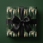Forest wrapping paper with a black satin bow, rustic Christmas gift wrap by Wrapped Studios.