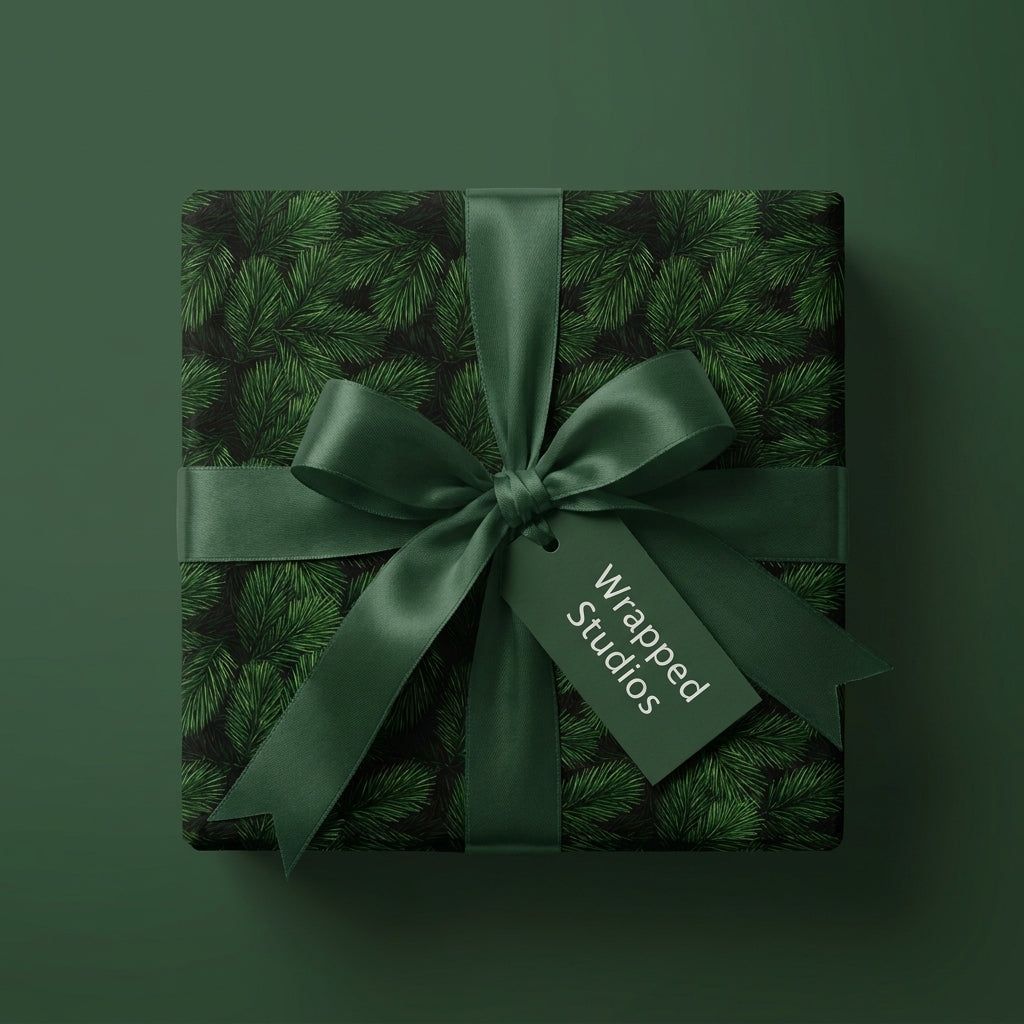 Luxury Christmas wrapping paper with green pine needle pattern and satin bow by Wrapped Studios.